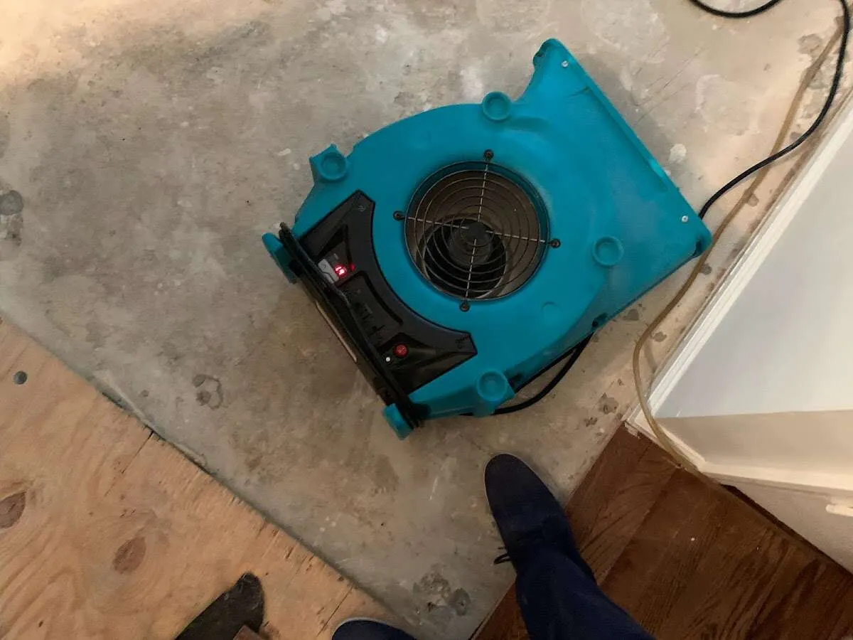 Air mover drying subfloor during Commercial Water Damage Restoration in Blue Island